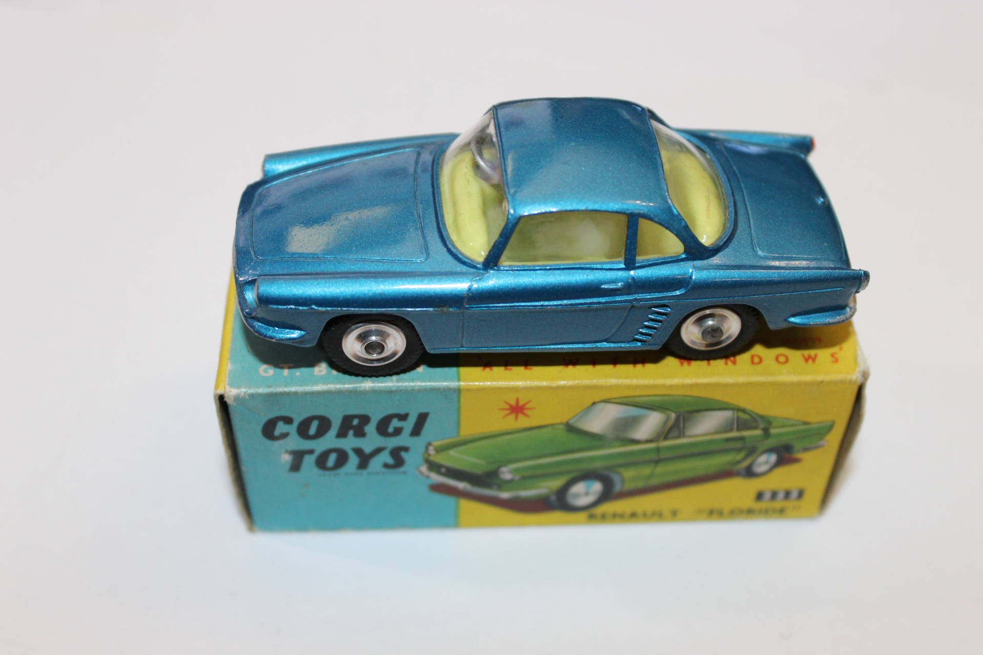 Detailed blue diecast Corgi toy car with yellow interior, displayed on its original packaging for co.