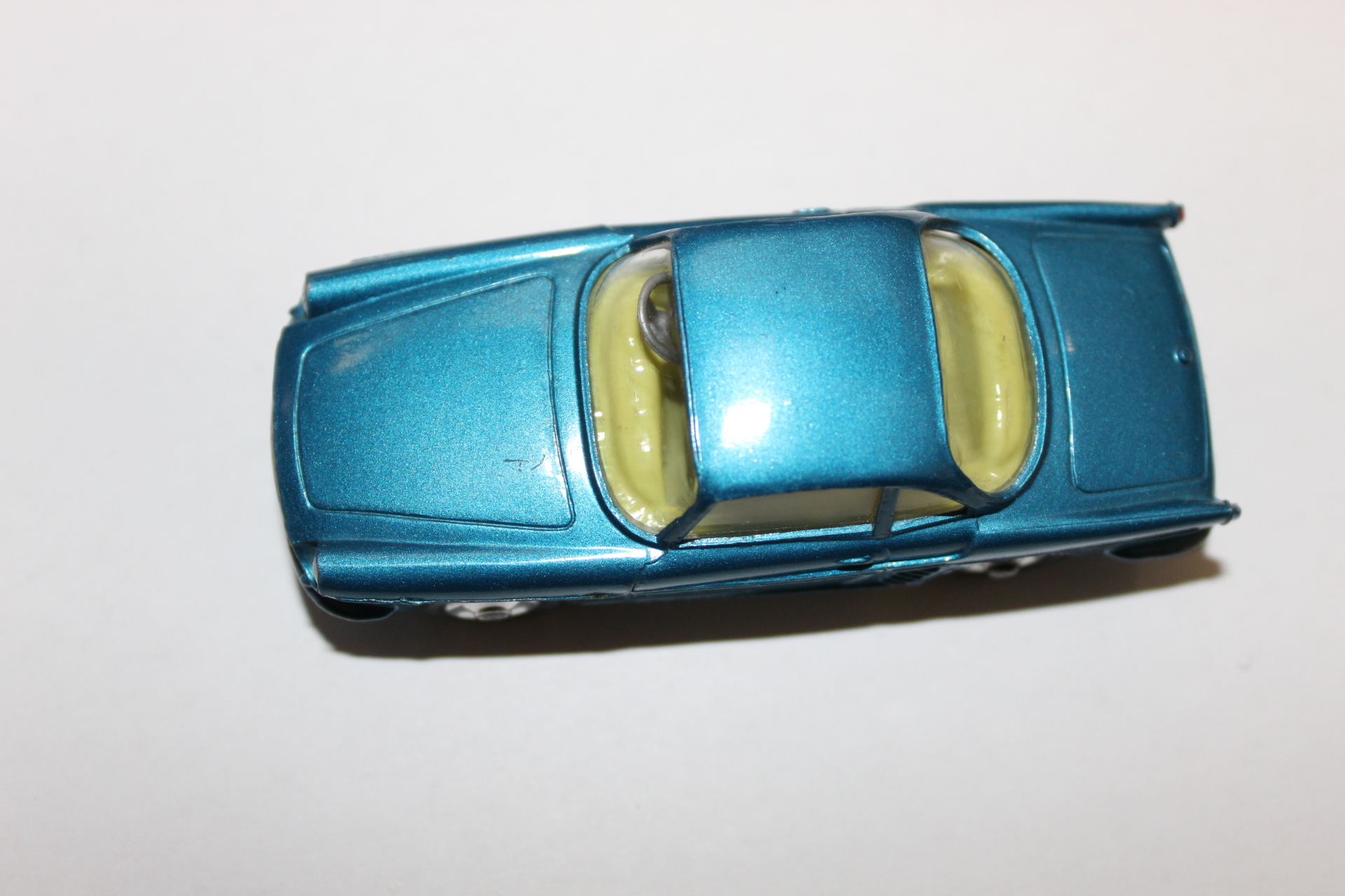 Diecast Gems blue vintage car toy with yellow windows, collectible diecast model.