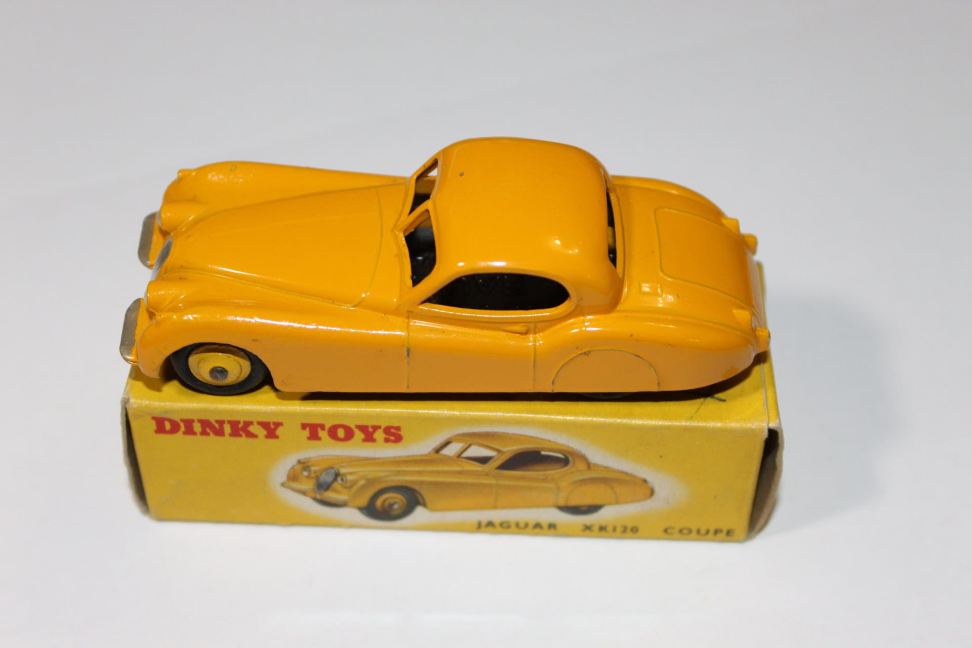 Vintage Dinky Toys 30C Daimler model car in yellow, with original box, collectible diecast vehicle.