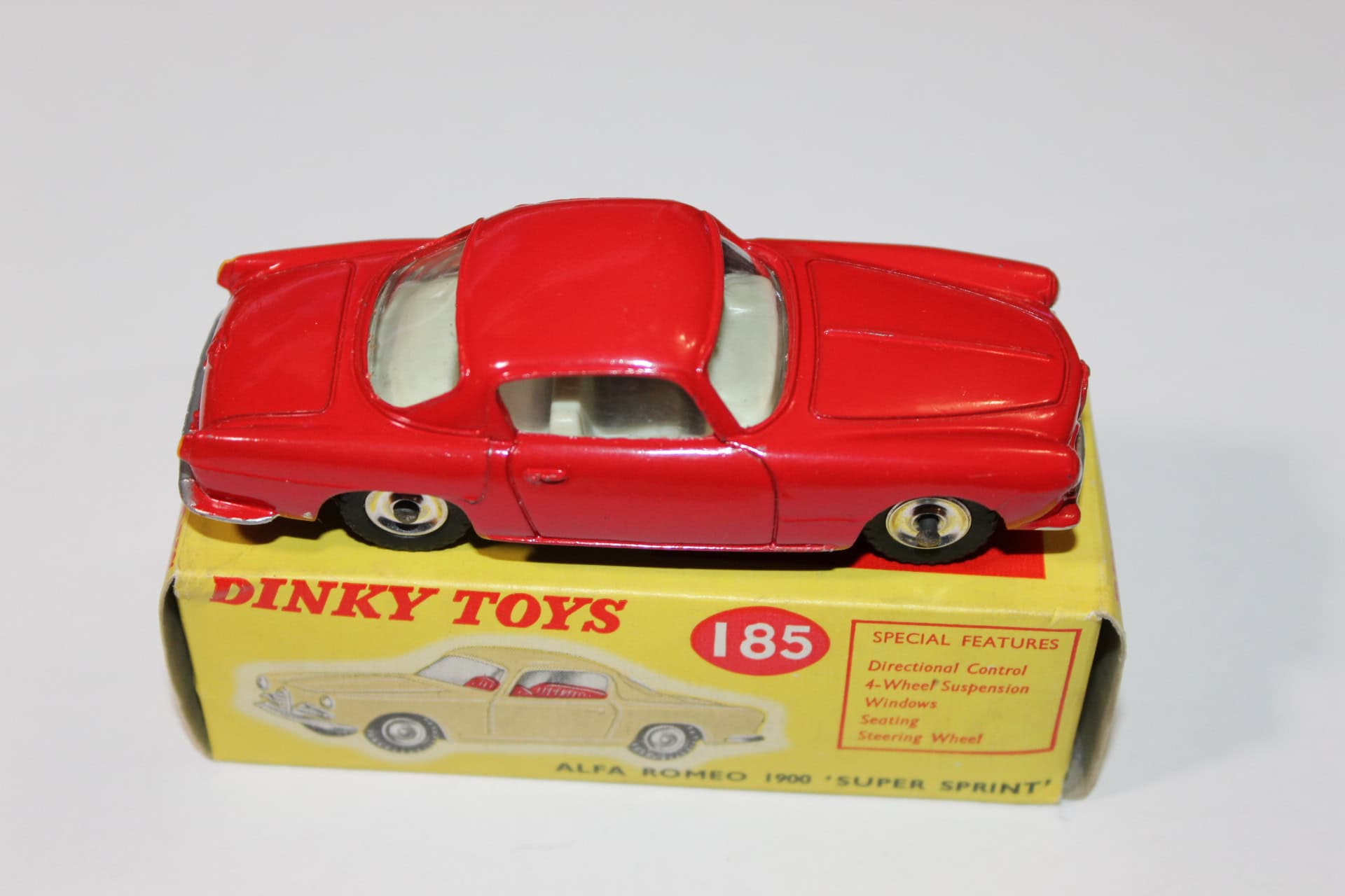Dinky Toys 185 Alfa Romeo 1900 Super Sprint diecast model car on yellow box, vintage collectible toy.