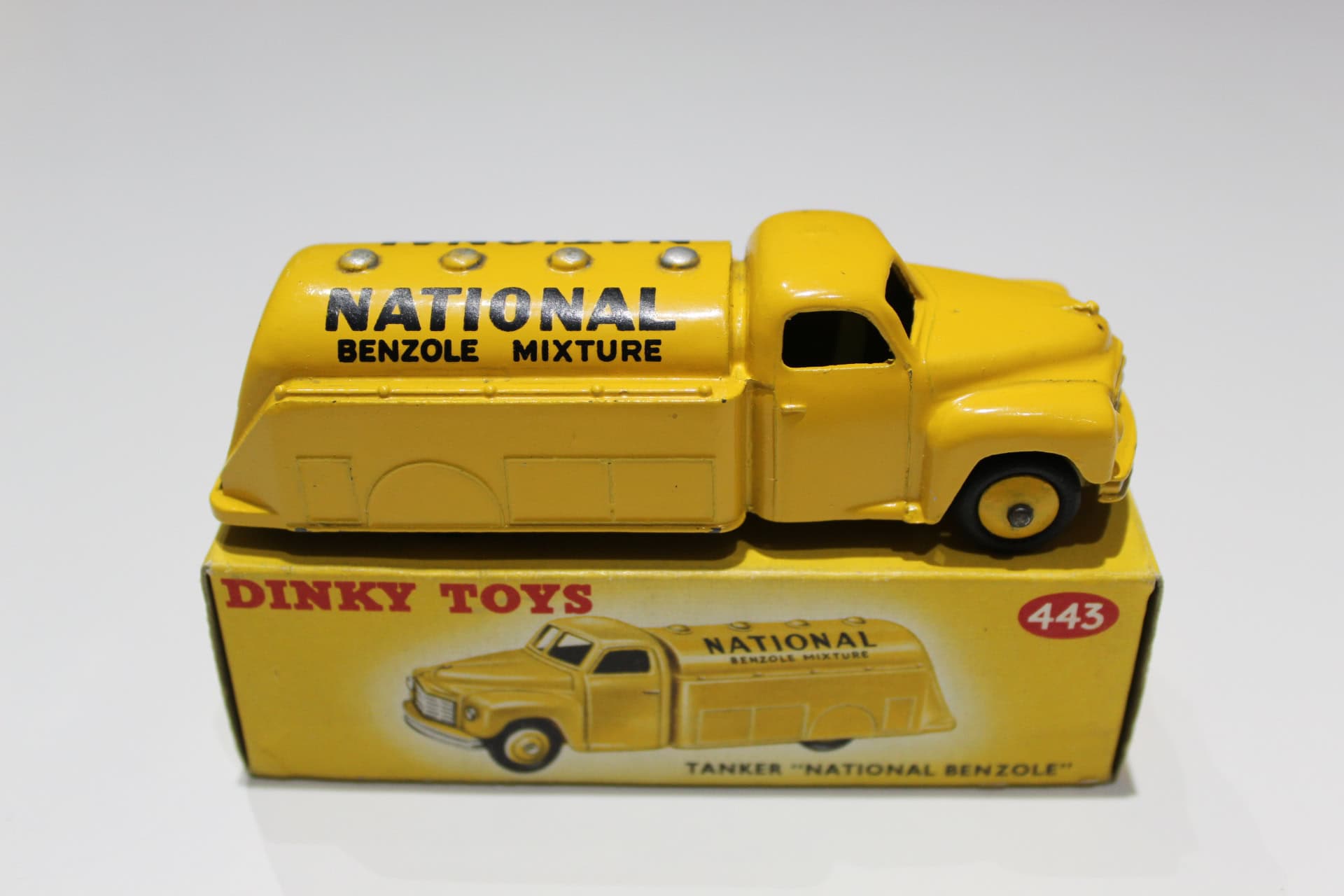 Vintage Dinky Toys 443 Studebaker tanker model in yellow with National Benzole branding.