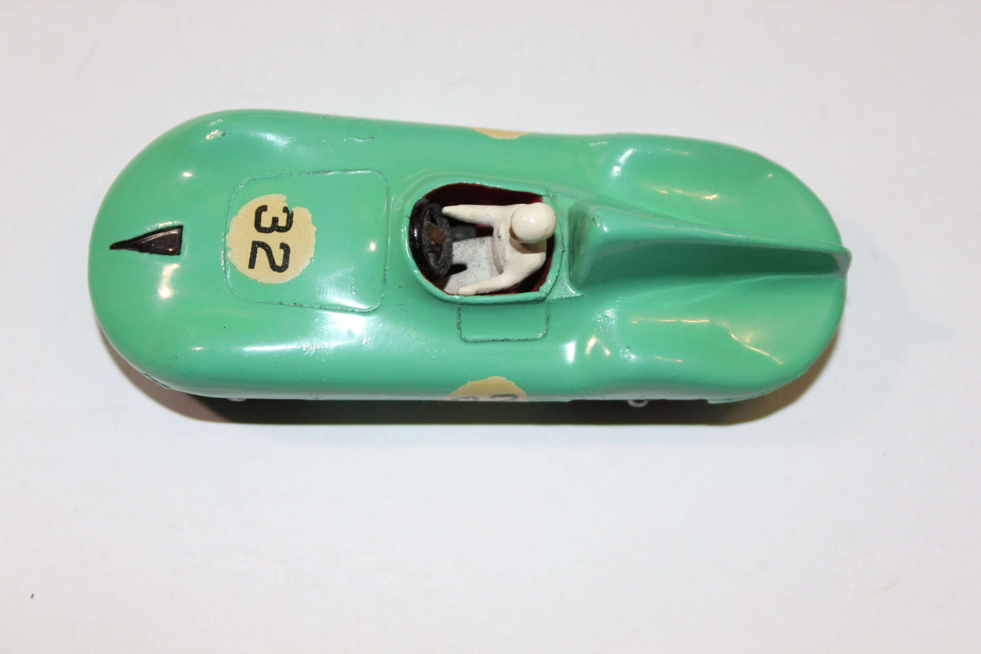 Vintage Dinky Toys Connaught Racing Car model in green with driver figure.