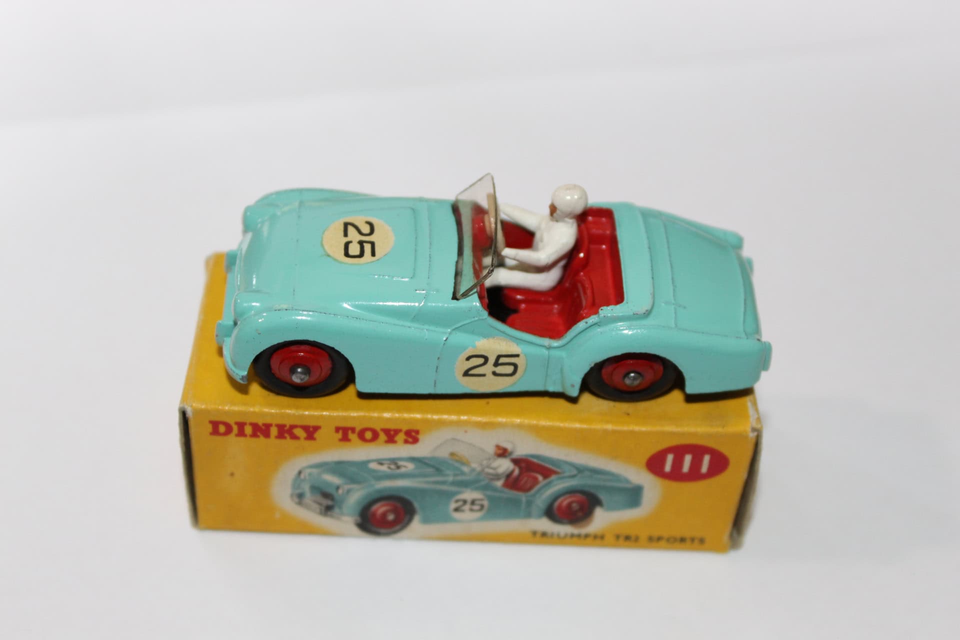 Vintage Dinky Toys Triumph TR2 model car with driver figure, collectible diecast toy.