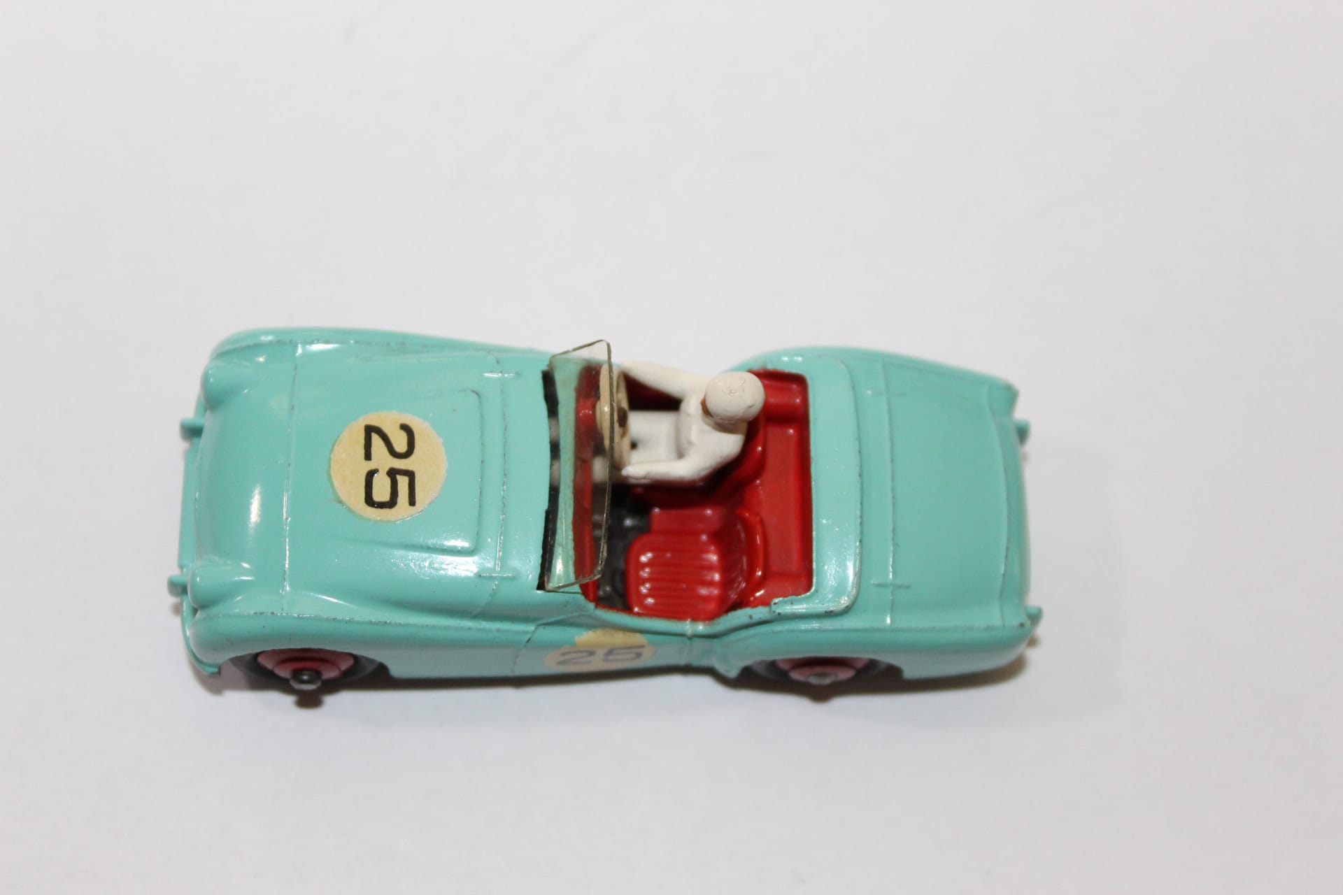 Vintage Dinky Toys Triumph TR2 model car with racing number 25, detailed interior, and light blue fi.