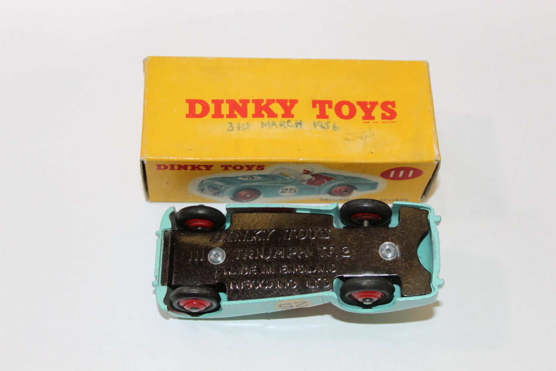 Vintage Dinky Toys Triumph TR2 sports car model in original packaging.