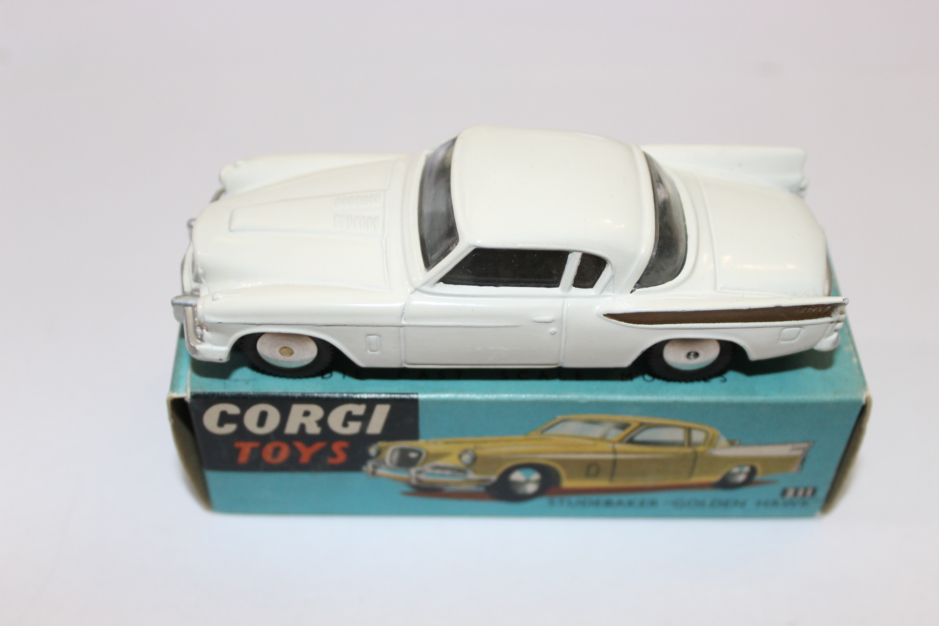 Vintage white diecast Corgi Toys car model on original box, collectible toy vehicle.