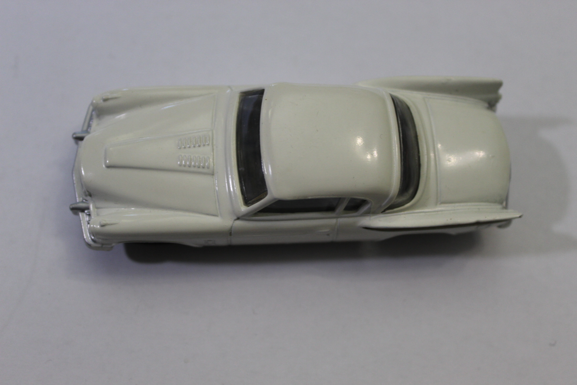 Vintage white diecast car model for collectors.