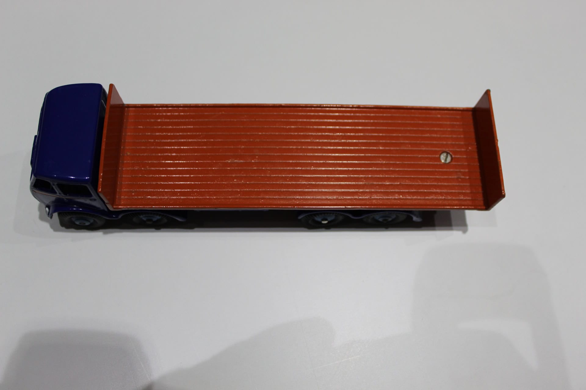 Dinky Toys 503 model flat truck with blue cab and brown cargo bed, detailed toy vehicle for collecto.