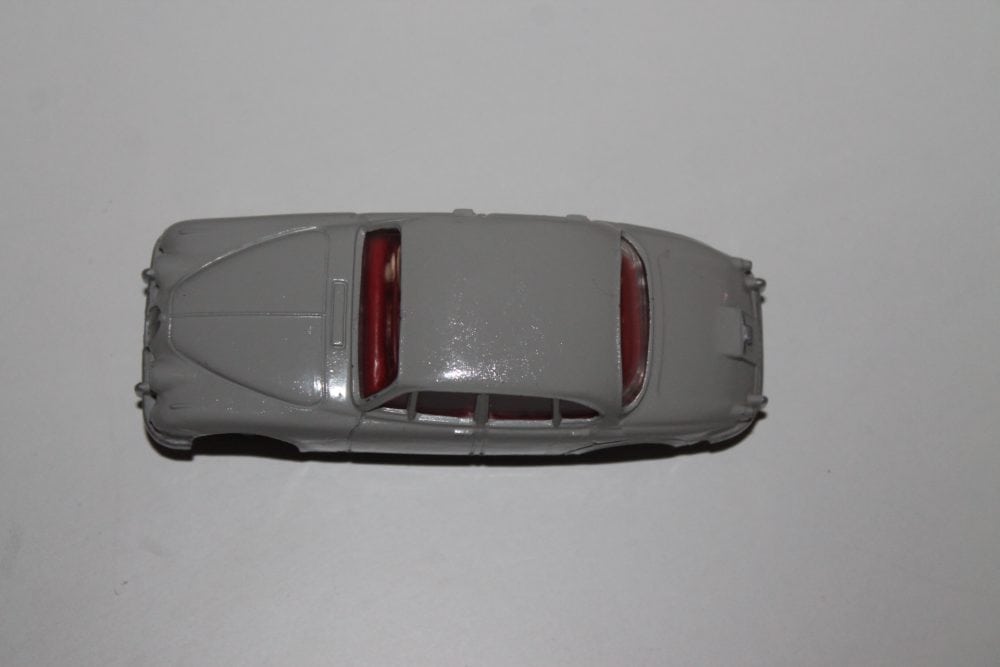 Dinky Toys 195 grey Jaguar 3.4 model car on white background.