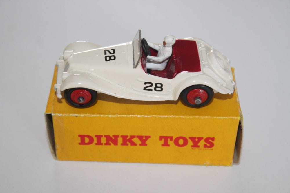 Vintage Dinky Toys 108 MG Midget race car with driver figure on yellow box.