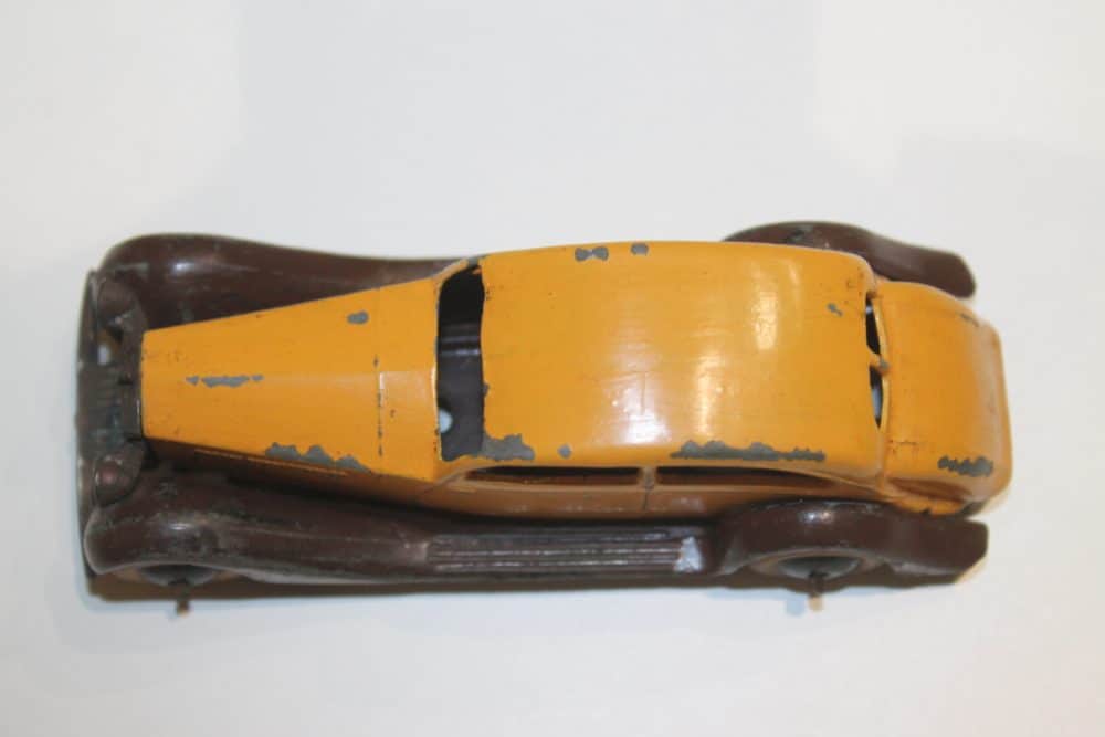 Vintage Dinky Toys 030b model of a Rolls Royce Pre-War car, yellow with brown base.