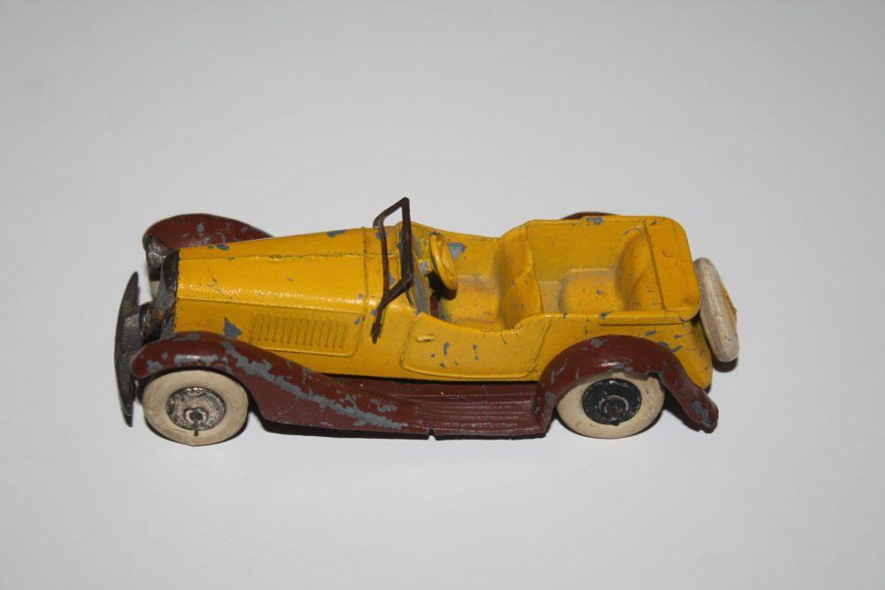 Vintage yellow and brown diecast sports car model with open-top design.
