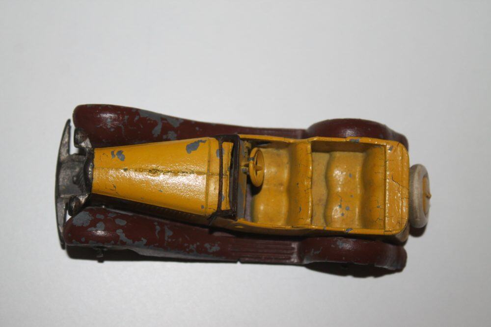Vintage Dinky Toys 024g model of a yellow and maroon sports car, top view.