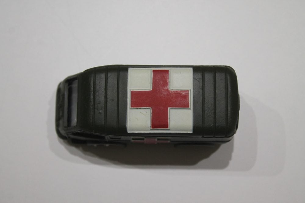 Vintage Dinky Toys military ambulance with red cross symbol, collectible diecast model.