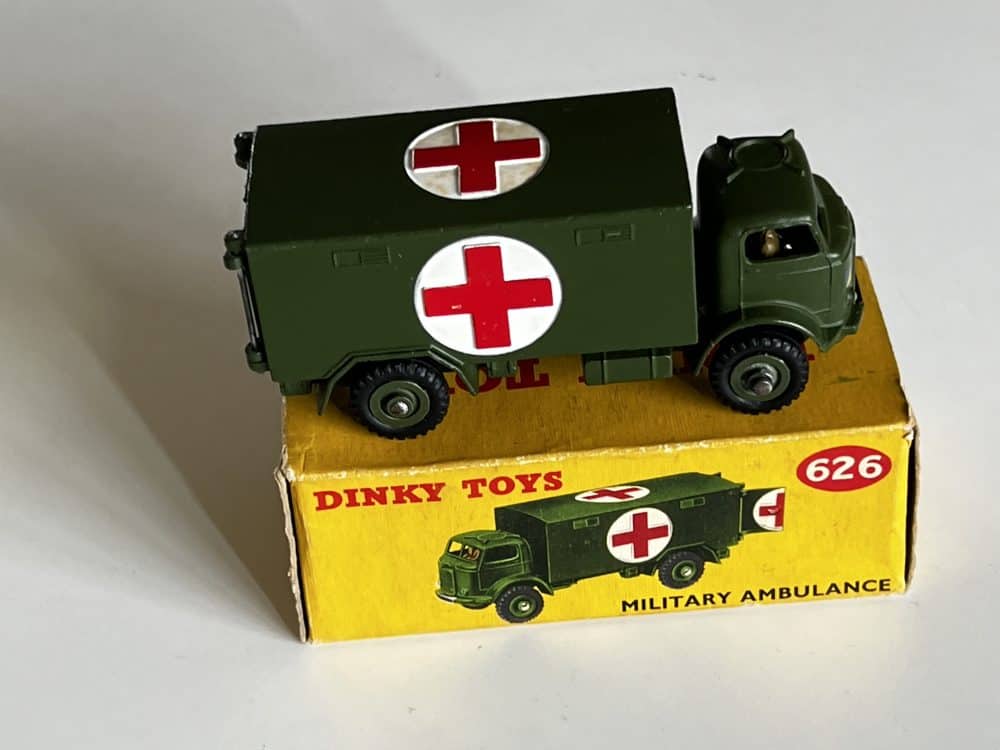 Vintage Dinky Toys 626 military ambulance model with red cross symbols.