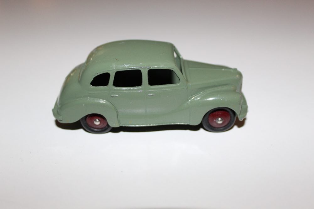Vintage Dinky Toys Austin Devon model car, green with red wheels, collectible diecast vehicle.