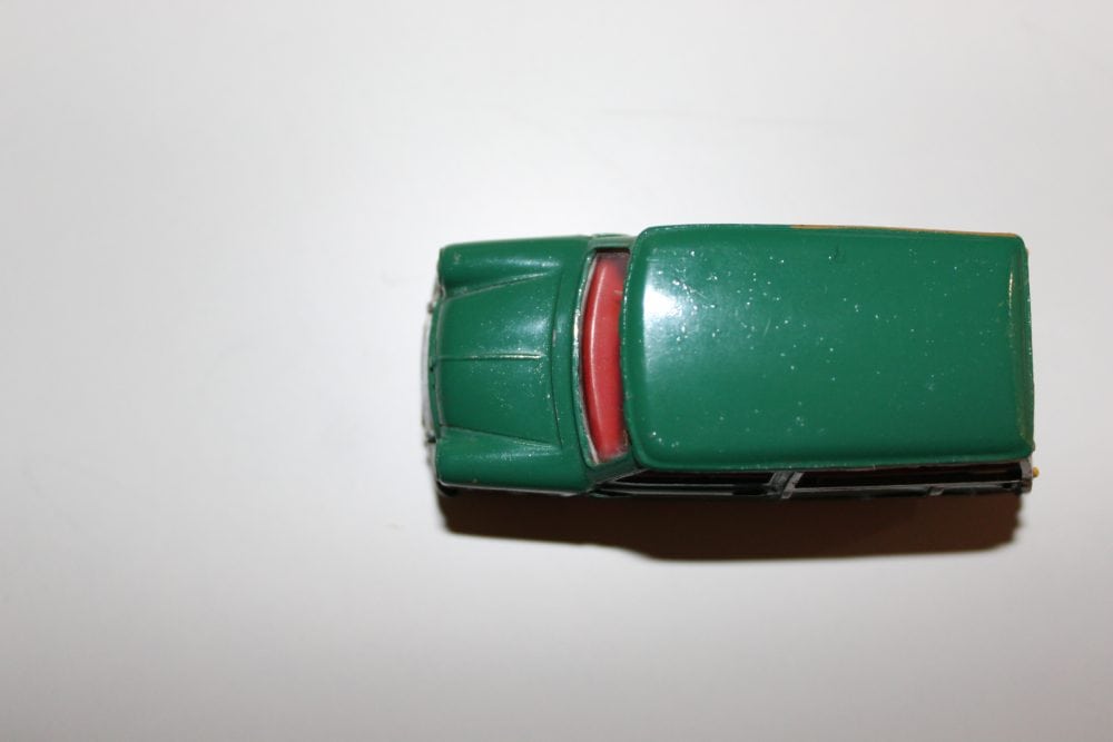 Mini Traveller diecast toy car in green with red interior, vintage model for collectors.