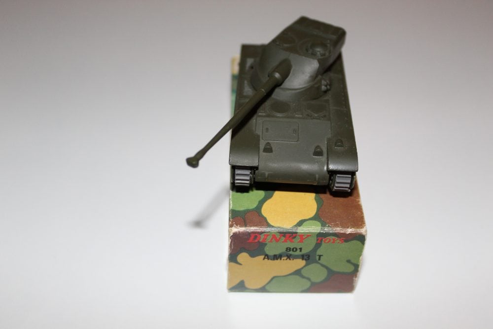 Dinky Toys 801 A.M.X. 13 T tank model on camouflage box, collectible diecast vehicle.