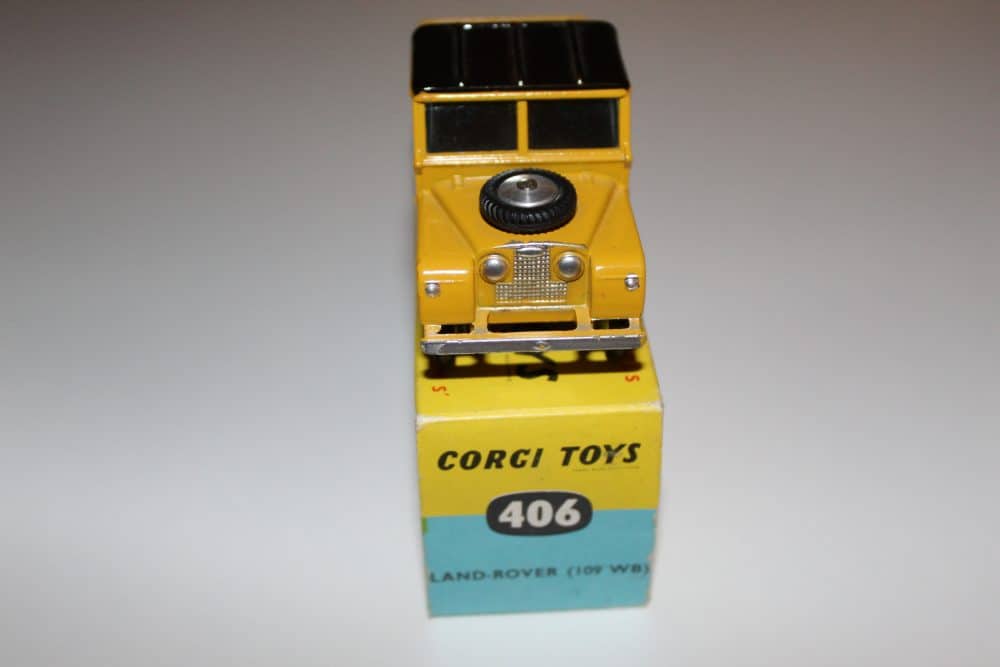 Vintage Corgi Toys 406 Land Rover diecast model, yellow with black roof, detailed miniature vehicle.