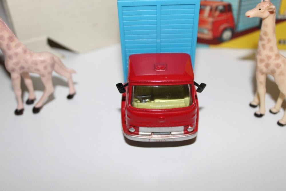 Vintage Corgi Giraffe Transporter toy with giraffe figures and circus backdrop.
