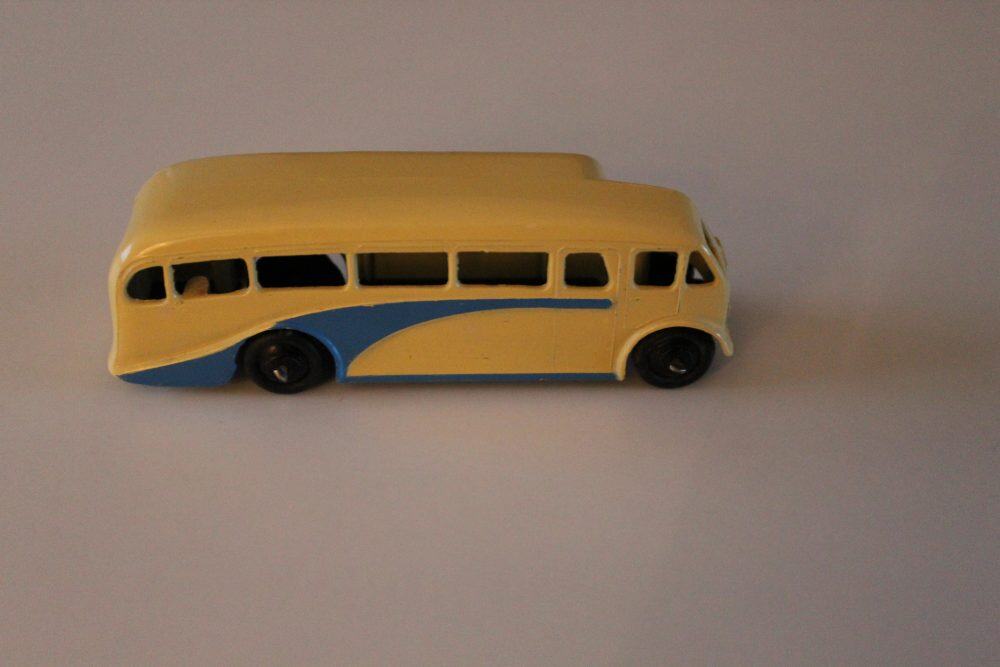 Dinky Toys 029e Half Cab Bus diecast model in yellow and blue, vintage toy vehicle.