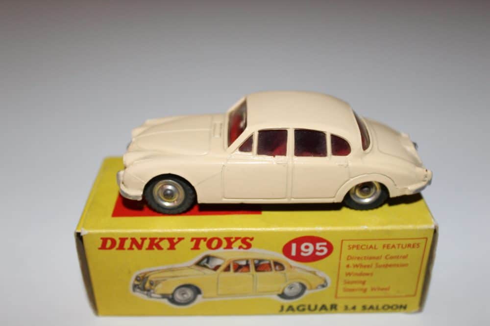 Vintage Dinky Toys 195 Jaguar 3.4 Saloon model on yellow box, detailed diecast collectible.