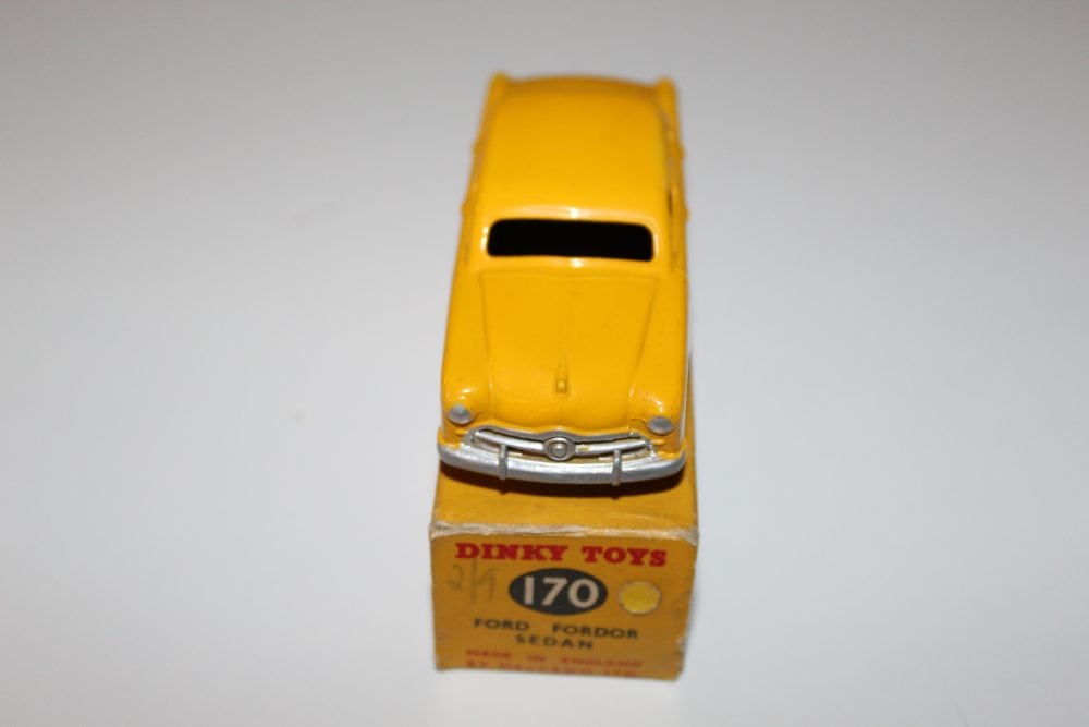 Vintage yellow diecast Ford model car, Dinky Toys 170 series, on original packaging.