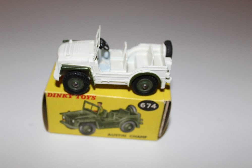Vintage Dinky Toys 674 'UN' Austin Champ diecast model on yellow box.