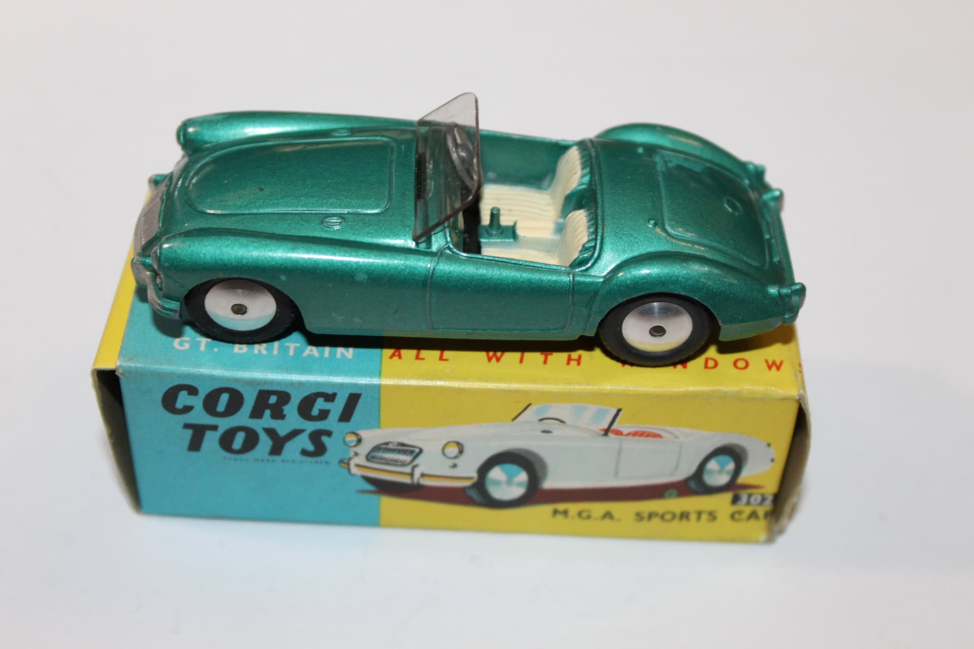 Vintage Corgi Toys 302 M.G.A. sports car model on original box, collectible diecast toy.