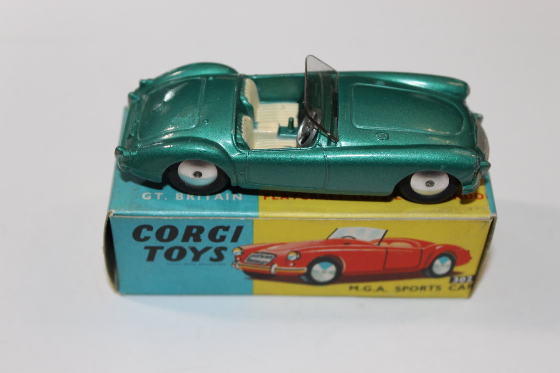 Vintage green Corgi Toys 302 M.G.A. sports car model on original box.
