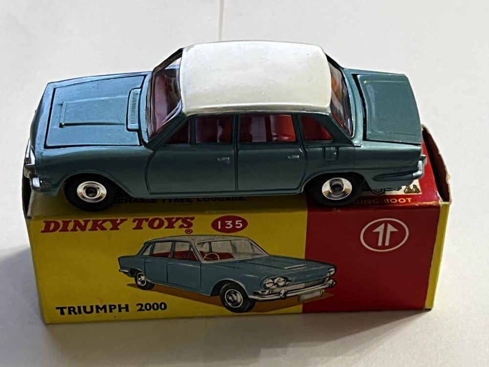Dinky Toys Triumph 2000 diecast model car on original box, collectible toy.
