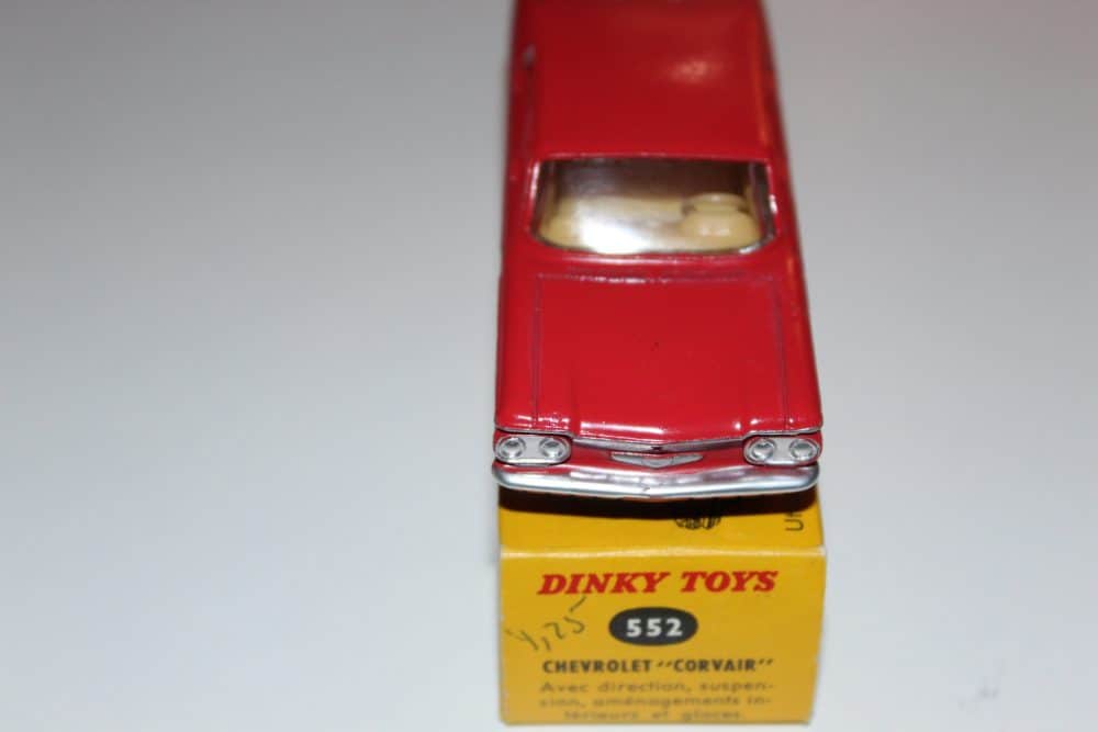 Vintage Dinky Toys 552 Chevrolet Corvair diecast model car, red with detailed interior.