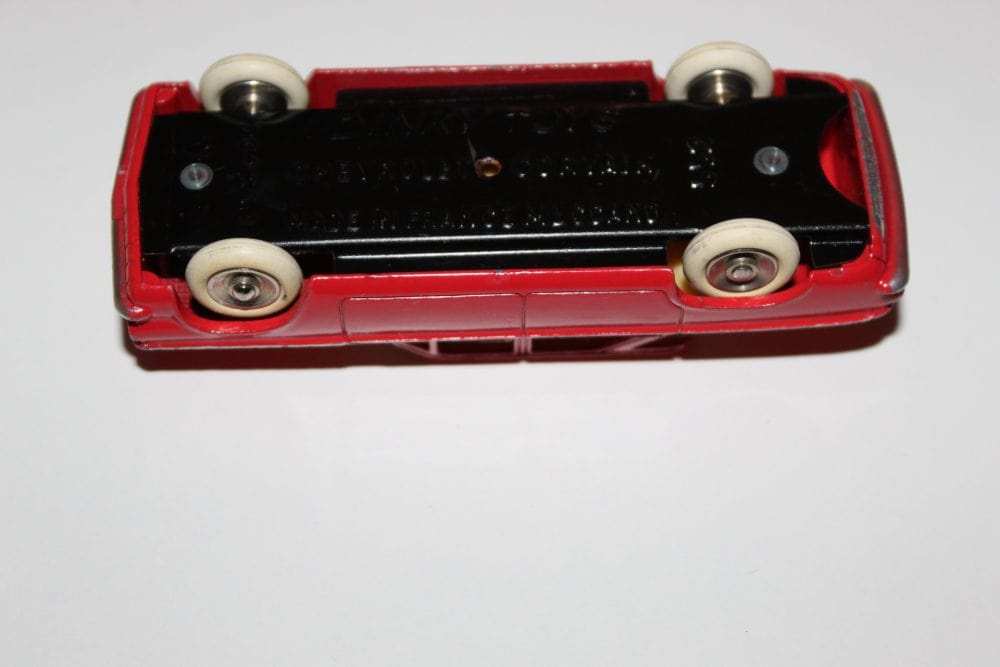 Vintage Dinky Toys 552 Chevrolet Corvair diecast model car, red with white wheels.