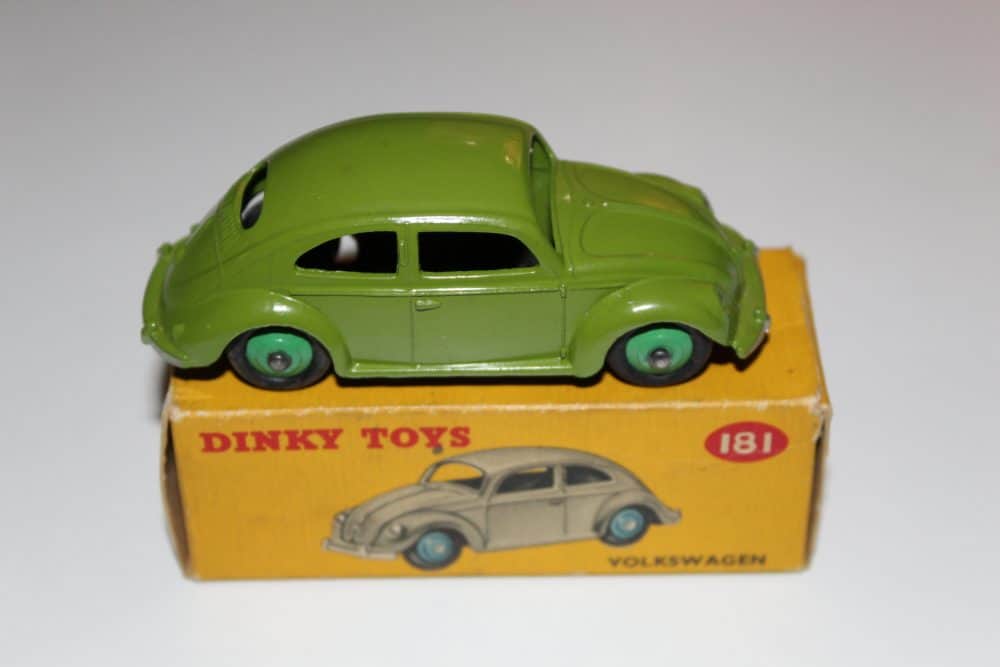 Vintage Dinky Toys 181 Volkswagen Beetle model car on yellow box, collectible diecast toy.