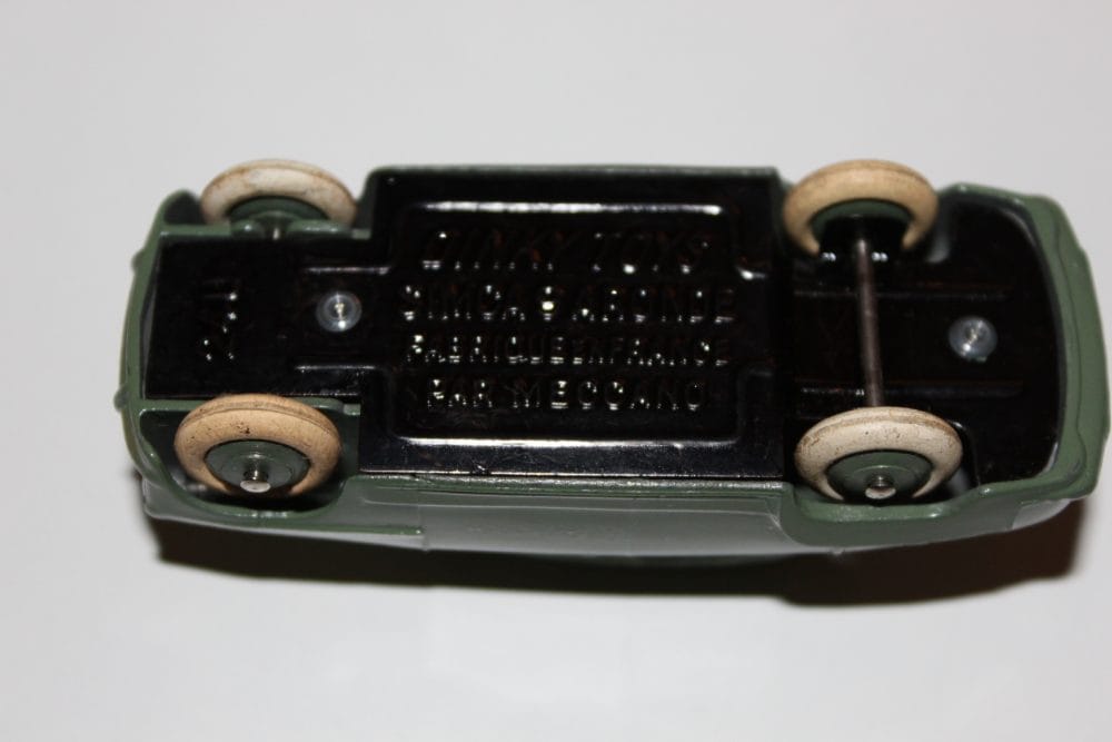 Close-up of Dinky Toys Simca 9 'Aronde' vintage diecast car underside showing wheels and chassis.