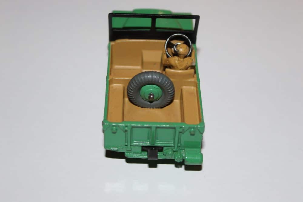 Vintage Dinky Toy Land Rover model with spare tire and open rear door.