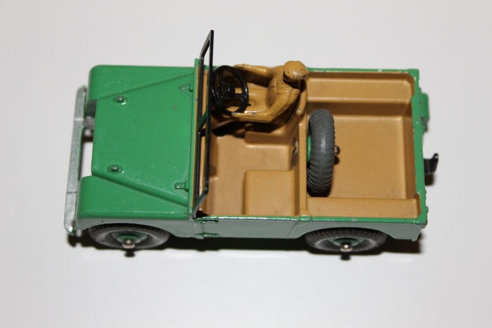 Dinky Toy Land Rover 027d/340 with driver figure and open cargo bed.