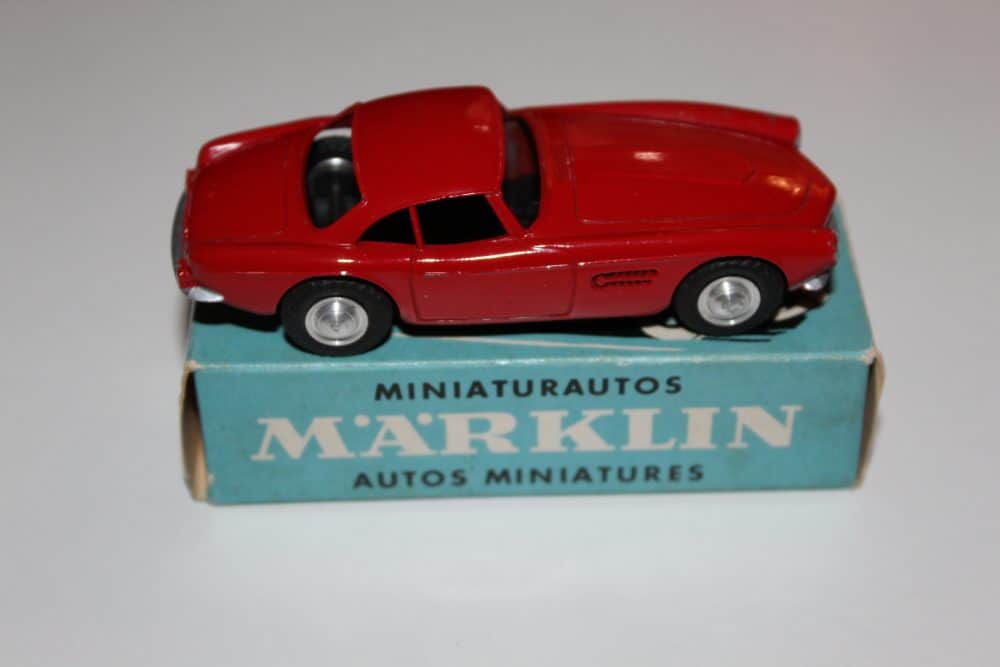 Miniature Marklin Sage Green BMW-507 toy car on blue box display.