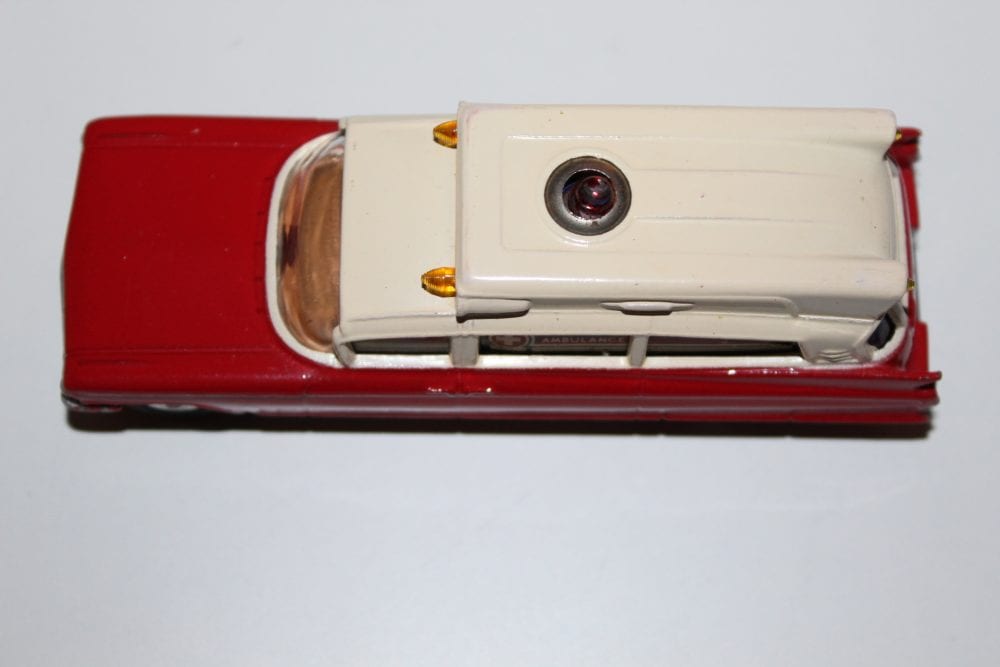 Vintage Dinky Toys Renault Dauphine model with attached camera, collectible diecast car.