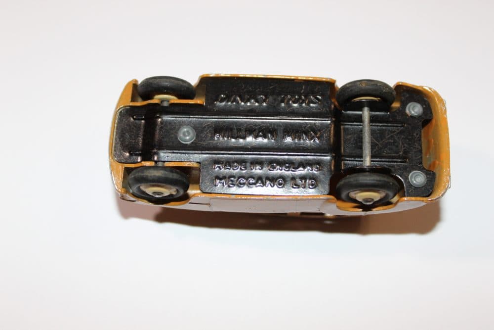 Vintage Dinky Toys 24E Renault Dauphine model in yellow with black wheels.