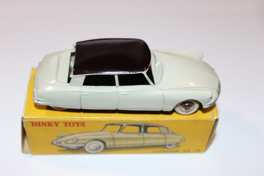 Dinky Toys French Citroen DS19 diecast car on original box, collectible vintage toy.