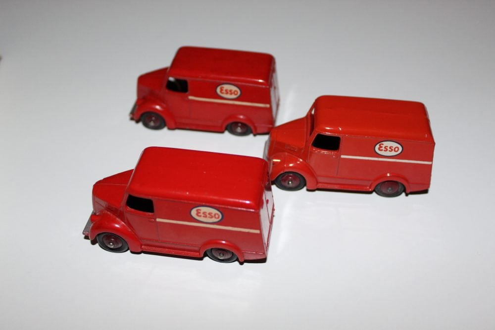Detailed model of three red Dinky Toys Trojan 'ESSO' vans for collectors.