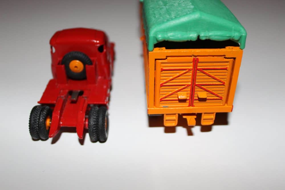Detailed model of French Dinky Willeme tractor with orange trailer and green cover.