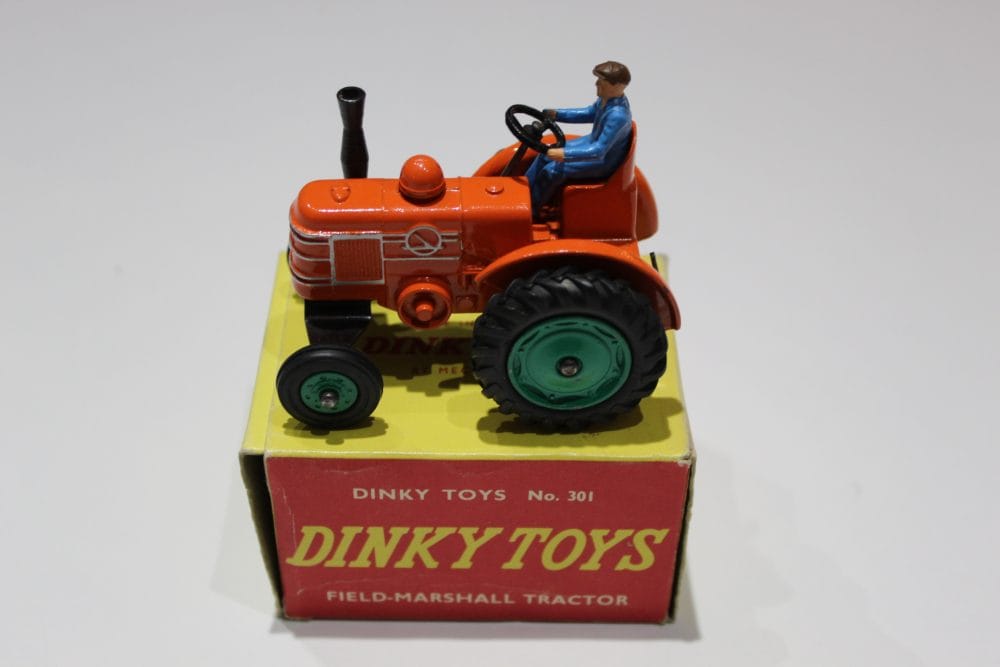Dinky Toys 301 Field Marshall Tractor diecast model with driver figure, vintage toy collectible.
