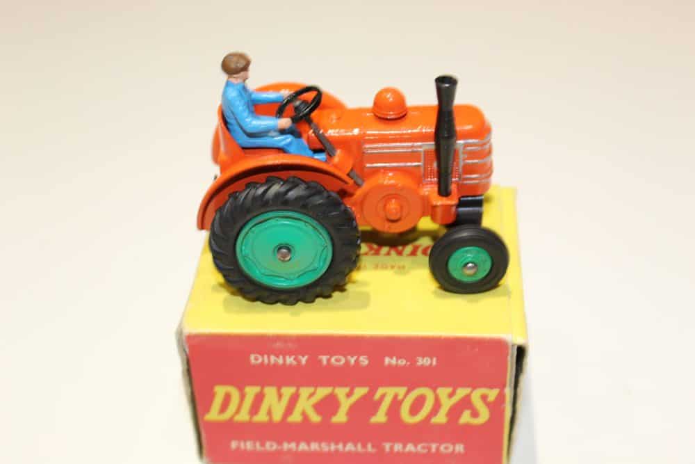Dinky Toys 301 Field Marshall Tractor with driver figure, vintage diecast model for collectors.