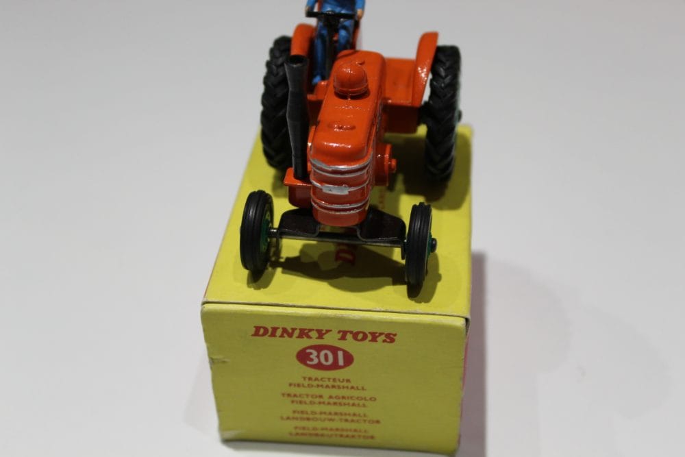 Dinky Toys 301 Field Marshall tractor model on yellow box, vintage diecast collectible.