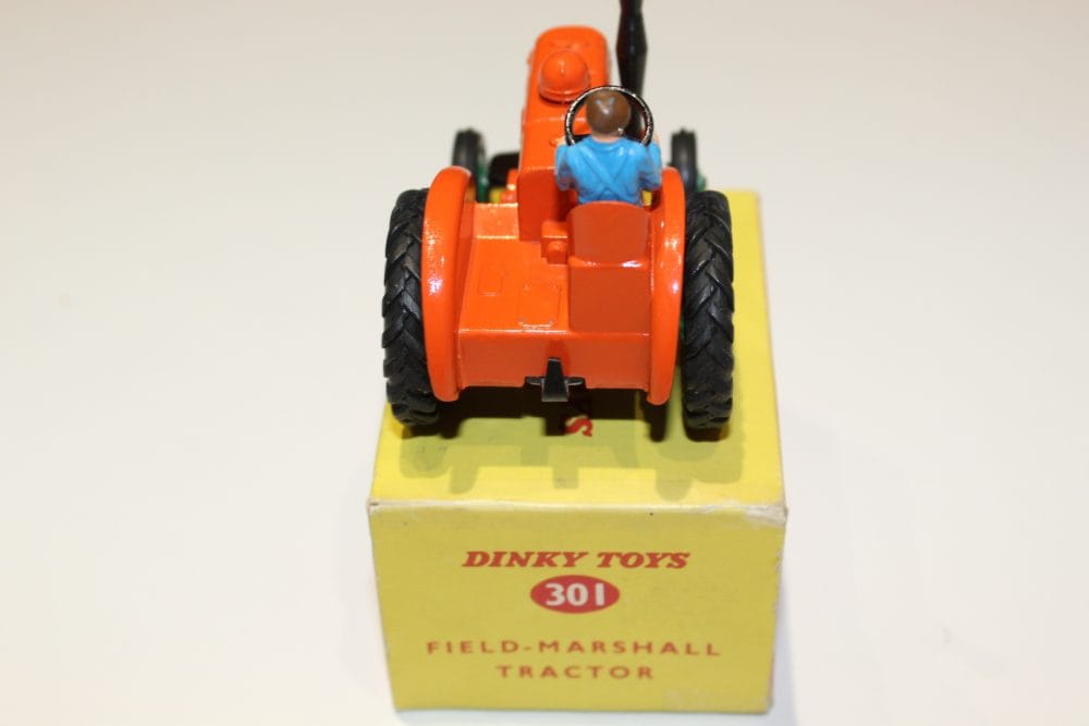 Vintage Dinky Toys 301 Field Marshall Tractor model with driver figure.