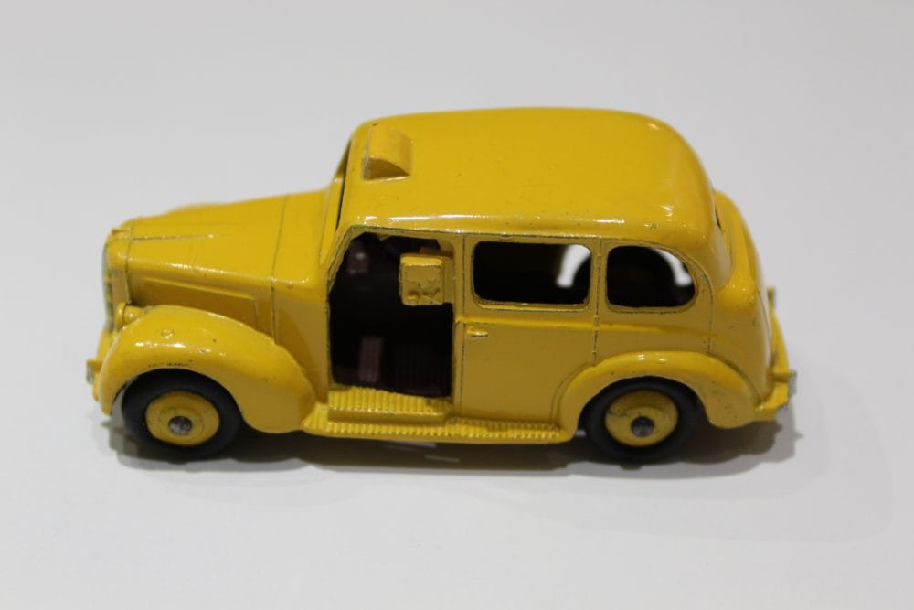 Vintage yellow Austin taxi diecast model for collectors.