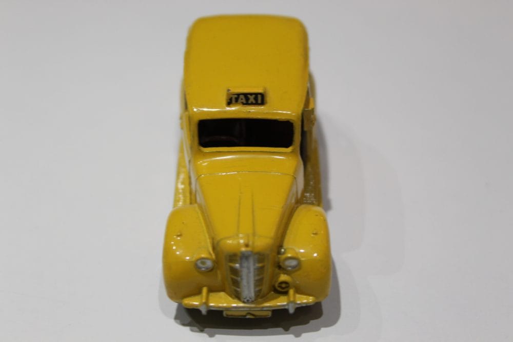 Vintage yellow Austin taxi diecast model for collectors.