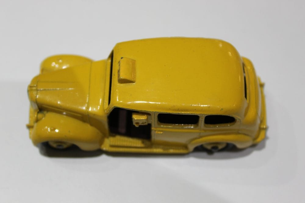 Vintage yellow Dinky Austin Taxi diecast model for collectors.